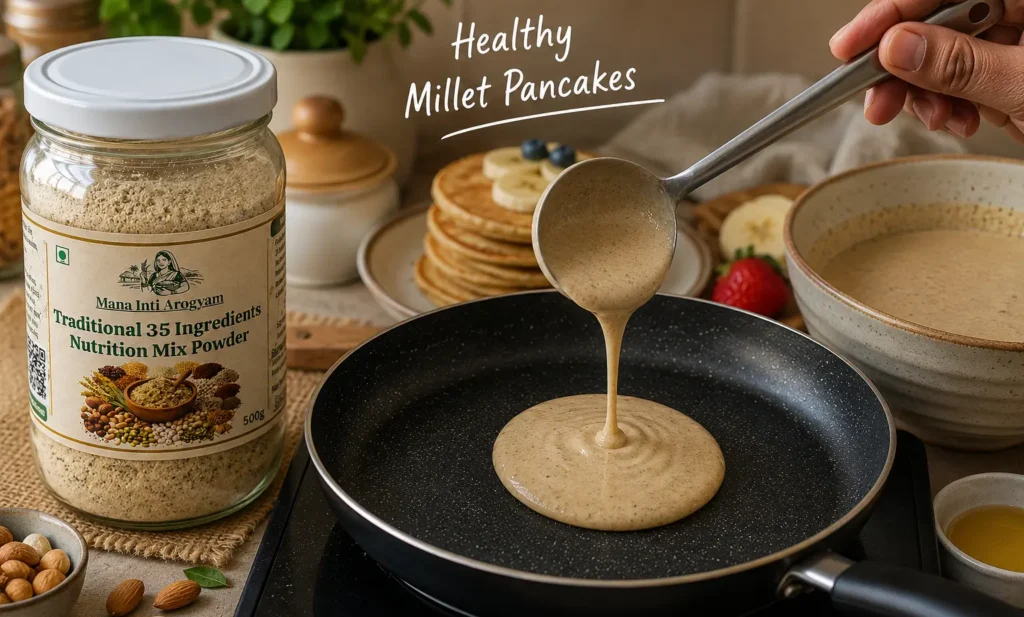 Healthy Millet Pancakes being prepared in a pan using Mana Inti Arogyam traditional 35 ingredients nutrition mix powder in a modern kitchen setup.